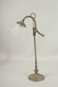 AN EDWARDIAN METAL LAMP with vaseline glass shade. 50cms high