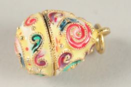 A TINY SILVER AND ENAMEL EGG PENDANT.
