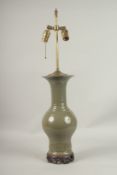 A CHINESE GREEN CRACKLE GLAZE LAMP on a wooden base.