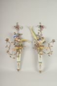 A GOOD PAIR OF GILT METAL AND PORCELAIN PHEASANTS WALL SCONCES with two candle sconces, flowers