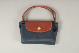 A LONGCHAMP BLUE FABRIC FOLDING BAG. 23cms x 12cms closed.