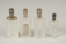 FOUR SILVER TOP SCENT BOTTLES.