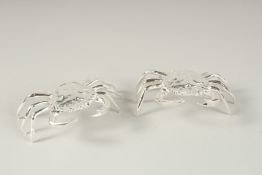 A SMALL PAIR OF PLATED CRAB SALTS.
