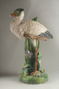 A MINTON FLOWER VASE, in the form of a heron modelled by John Henk. Circa. 1880. 65cms high. Mark on