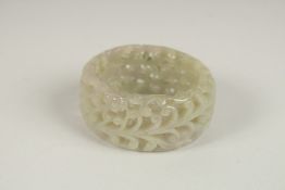 A PIERCED CELADON JADE BANGLE. 7cms diameter.