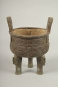 AN ARCHAIC BRONZE TWO HANDLED CIRCULAR CENSER. 23cms high x 16cms wide.