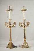 A PAIR OF 19TH CENTURY FIVE-LIGHT BRONZED CANDLESTICKS. 60cms high.