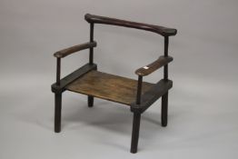 A CARVED HARDWOOD LOW CHAIR. 59cm wide.
