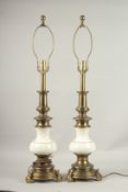 A PAIR OF BRASS AND WHITE PORCELAIN STIFFEL LAMPS. 56cms high.