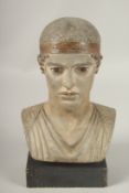 A MUSEUM COPY OF A ROMAN TERRACOTTA HEAD. 23cms on a wooden base.