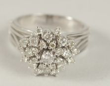 AN 18CT WHITE GOLD AND DIAMOND CLUSTER RING.