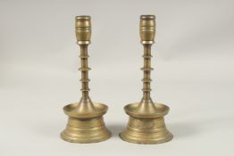A PAIR OF 17TH CENTURY DUTCH BRASS CANDLESTICKS. 25cms high.