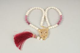 A SILVER AND GOLD PLATED PANTHER NECKLACE with pearls and rubies.