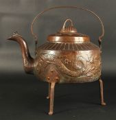 A GOOD LARGE NEWLYN CIRCULAR COPPER KETTLE on three curving legs, the sides repousse with dragons,