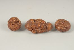 THREE CHINESE CARVED WOOD NETSUKES.