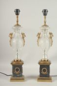 A GOOD PAIR OF CUT GLASS URN SHAPED LAMPS on pedestal bases.