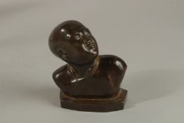 N.P., A GOOD QUALITY BRONZE BUST, head and shoulders of a child. 19cms high. Initial N.P.