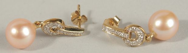 A PAIR OF 9CT YELLOW GOLD ART DECO STYLE PINK CULTURED PEARL EARRINGS with diamond-set drop bales,
