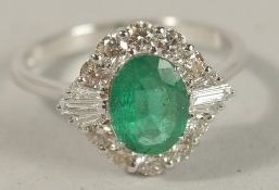 AN 18CT WHITE GOLD OVAL EMERALD AND DIAMOND CLUSTER RING. Emerald 1.05ct. Diamonds 0.60ct (RBC 0.