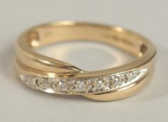 A 9CT YELLOW GOLD TWIST RING set with R/C diamonds (0.10ct approx).