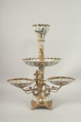 A GILT METAL AND PORCELAIN THREE TIER COMPORT, the porcelain dishes painted with birds. 60cms high.