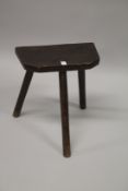 A CUTLERS WOODEN THREE LEGGED STOOL stamped 