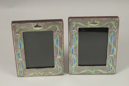 A PAIR OF SILVER AND BLUE ENAMEL PHOTOGRAPH FRAMES. 20cms x 14cms.