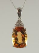 A GOOD CITRINE AND DIAMOND PENDANT on a fine white 14ct gold chain.