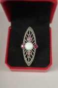 A SILVER OPAL AND RUBY RING.