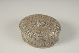 A TIBETAN SILVER OVAL BOX. 6.5cms.