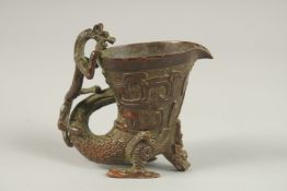 A GOOD BRONZE LIBATION CUP with dragon handle. 9cms high.