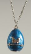 A STERLING SILVER AND BLUE ENAMEL EGG PENDANT AND CHAIN, set with four diamonds.