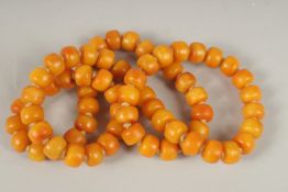 AN AMBER NECKLACE. 72cms high.