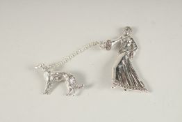 A SILVER AND MARCASITE LADY WITH A DOG BROOCH.