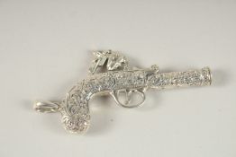 A SILVER NOVELTY GUN WHISTLE. 6cms long.