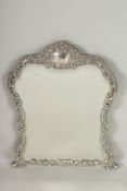 A SILVER DRESSING TABLE MIRROR with scroll decoration. 43cms high.