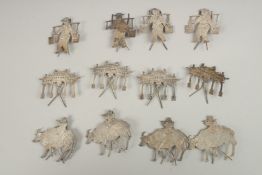 A SET OF TWELVE CHINESE SILVER CARVINGS.
