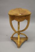 A FRENCH STYLE BLOND WOOD SHAPED TOP OCCASIONAL TABLE, with a small drawer, on curving supports.