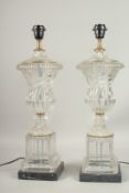A GOOD PAIR OF GLASS URN SHAPED LAMPS on marble bases. 60cms high.