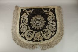 A SILVER THREADED IHS TEXTILE. 58cms x 58cms.