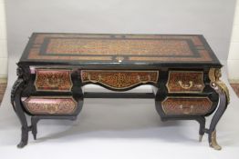 A VERY LARGE LOUIS XIV STYLE DESK after a model by ANDRE-CHARLES BOULLE with brasss inlay on red