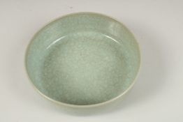 A CHINESE CELADON BOWL. 16.5cms diameter.