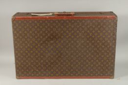 A LOUIS VUITTON SUITCASE with leather handle and brass mounts. 80cms long x 50cms wide x 20cms