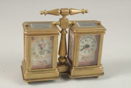 A DOUBLE BRASS SEVRES DESIGN CARRIAGE CLOCK with carrying handle. 12cms wide.