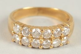 A 9CT YELLOW GOLD DOUBLE ROW OF TWELVE DIAMONDS.