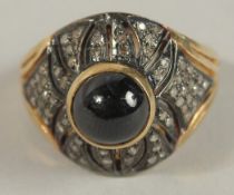 A SILVER GILT RING rubover set with a cabochon sapphire and several rose-cut diamonds. Sapphire 3.