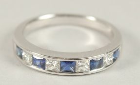 A HALLMARKED 18CT WHITE GOLD, SAPPHIRE AND DIAMOND HALF HOOP ETERNITY RING.