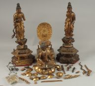 A COLLECTION OF THREE GILDED CARVED WOOD BUDDHAS AND ACCESSORIES, including stands and various