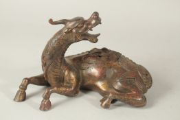 A BRONZE FIGURAL BEAST-FORM CENSER, with traces of gilt and red paint, 27cms long.