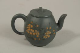 A SMALL CHINESE GREEN YIXING TEAPOT, with carved flora and calligraphy, the base with impressed